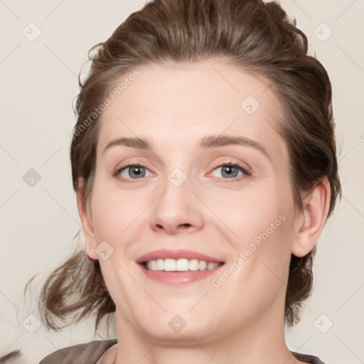 Joyful white young-adult female with medium  brown hair and blue eyes