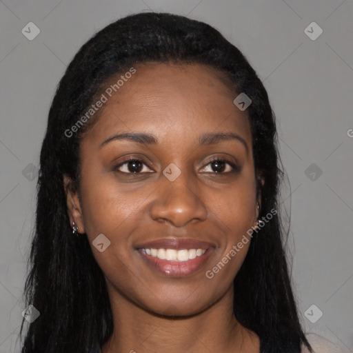 Joyful black young-adult female with long  black hair and brown eyes