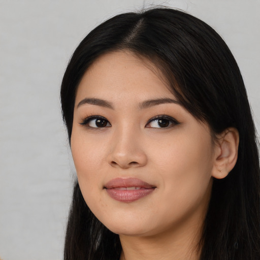 Joyful asian young-adult female with long  black hair and brown eyes