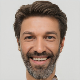 Joyful white adult male with short  brown hair and brown eyes