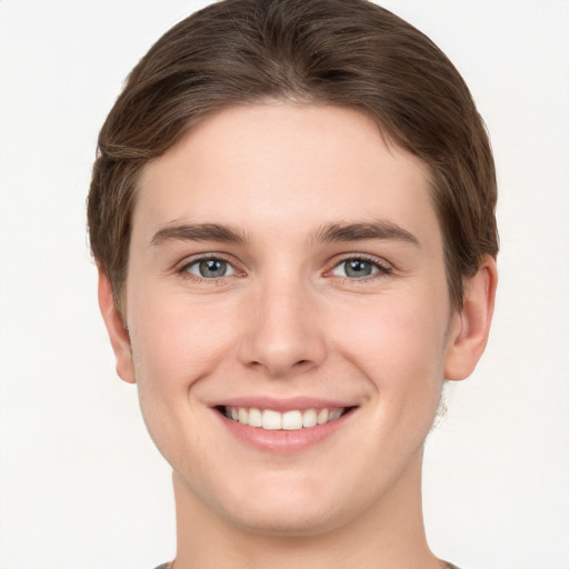 Joyful white young-adult female with short  brown hair and grey eyes