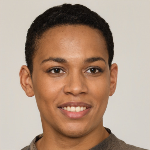Joyful latino young-adult female with short  black hair and brown eyes