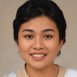 Joyful asian young-adult female with medium  black hair and brown eyes