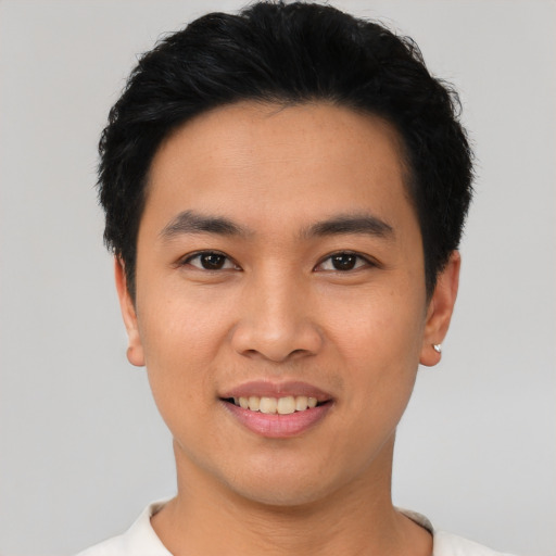 Joyful asian young-adult male with short  black hair and brown eyes