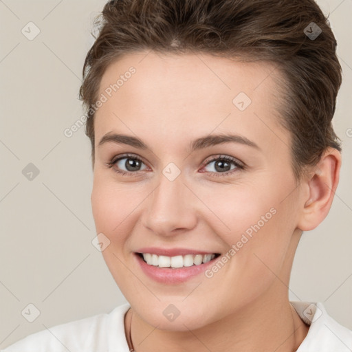 Joyful white young-adult female with short  brown hair and brown eyes