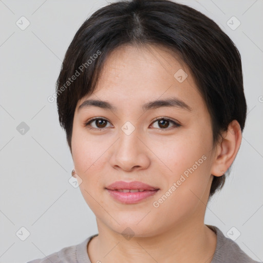 Joyful asian young-adult female with short  brown hair and brown eyes