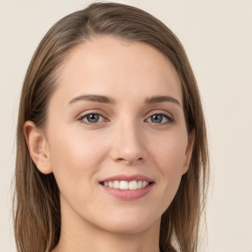 Joyful white young-adult female with long  brown hair and grey eyes