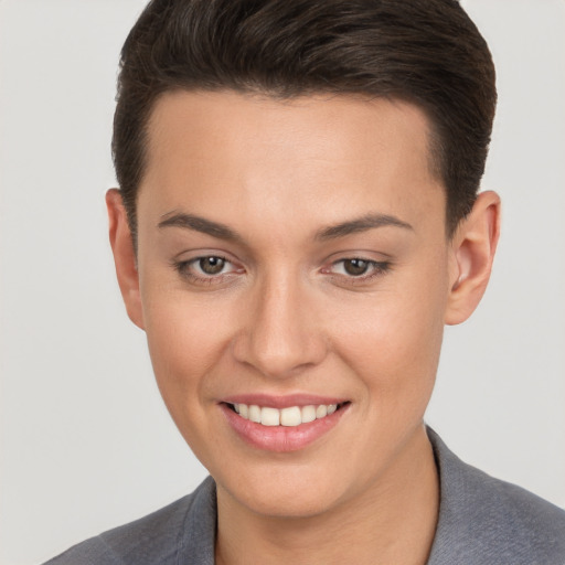 Joyful white young-adult female with short  brown hair and brown eyes