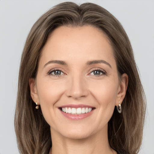 Joyful white young-adult female with medium  brown hair and grey eyes