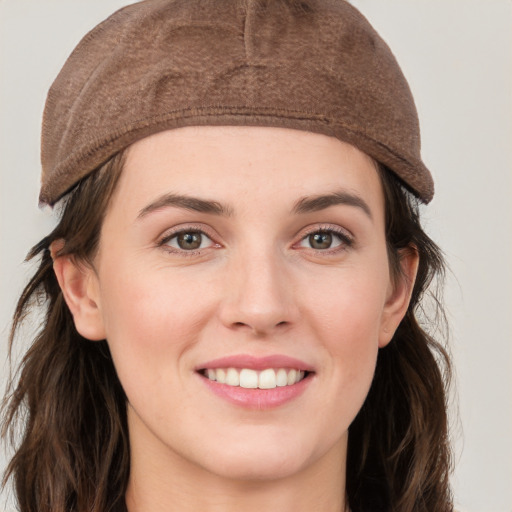 Joyful white young-adult female with long  brown hair and grey eyes