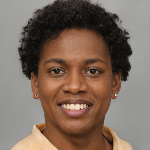 Joyful black young-adult female with short  brown hair and brown eyes