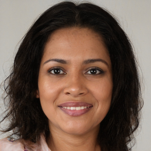 Joyful black young-adult female with medium  brown hair and brown eyes