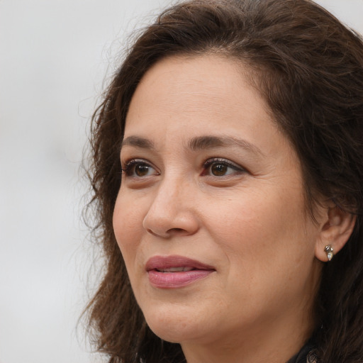 Joyful white adult female with long  brown hair and brown eyes