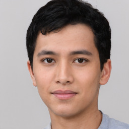 Joyful asian young-adult male with short  black hair and brown eyes