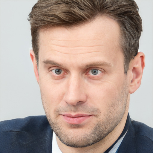 Joyful white adult male with short  brown hair and grey eyes