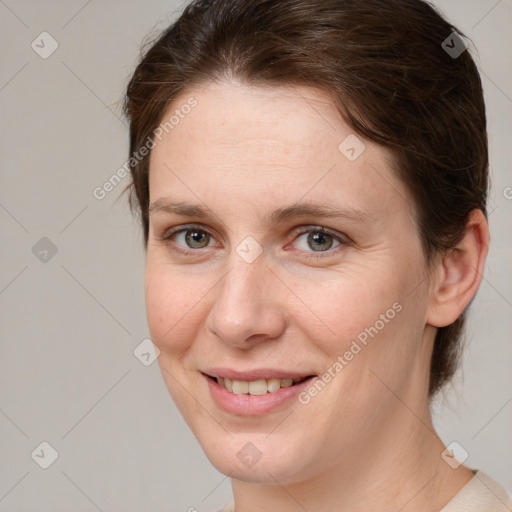 Joyful white adult female with medium  brown hair and grey eyes