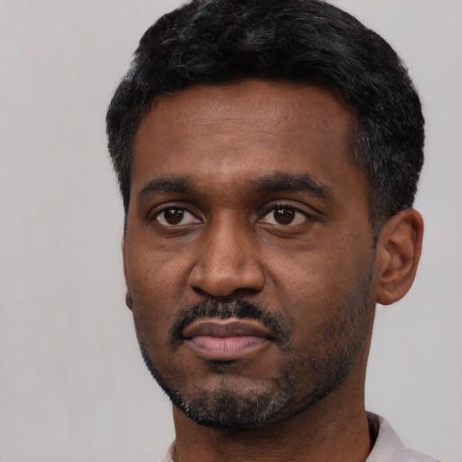 Neutral black adult male with short  black hair and brown eyes