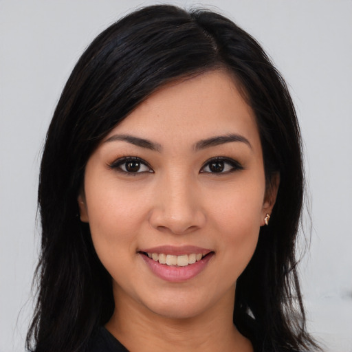 Joyful asian young-adult female with long  black hair and brown eyes