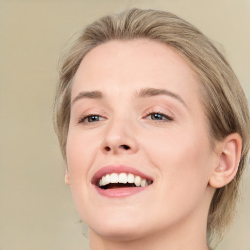 Joyful white young-adult female with medium  brown hair and green eyes