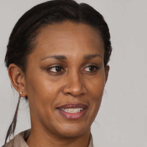 Joyful black adult female with short  brown hair and brown eyes