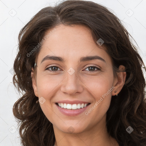 Joyful white young-adult female with long  brown hair and brown eyes