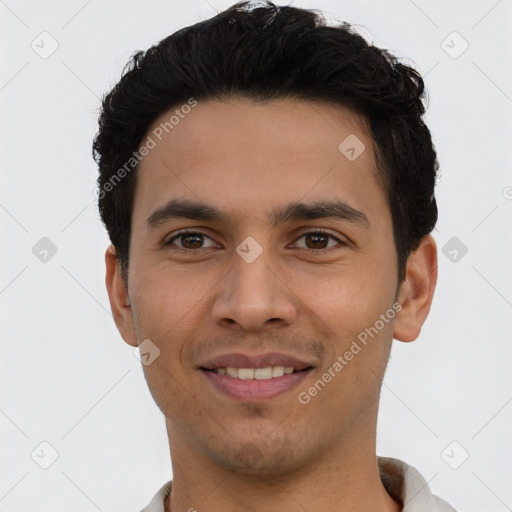 Joyful latino young-adult male with short  black hair and brown eyes