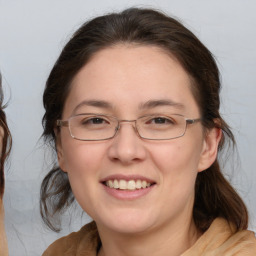 Joyful white adult female with medium  brown hair and brown eyes