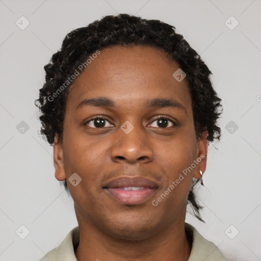 Joyful black young-adult male with short  black hair and brown eyes