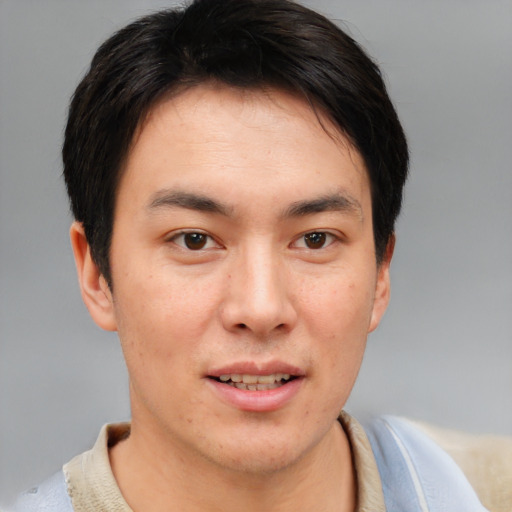 Joyful asian young-adult male with short  brown hair and brown eyes