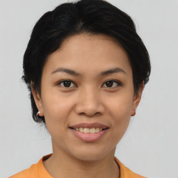 Joyful asian young-adult female with short  brown hair and brown eyes