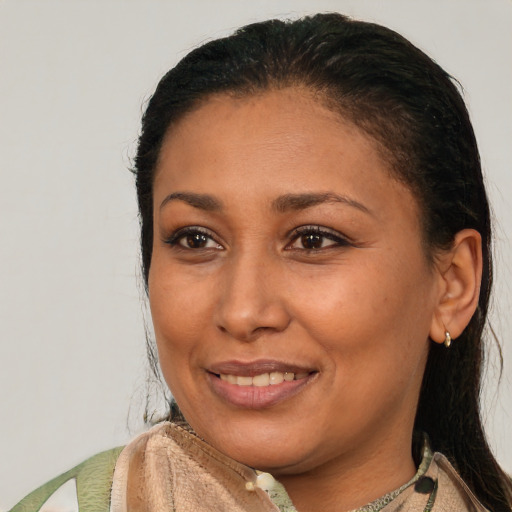 Joyful latino young-adult female with medium  brown hair and brown eyes