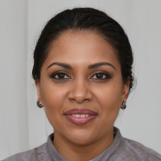 Joyful black young-adult female with medium  brown hair and brown eyes