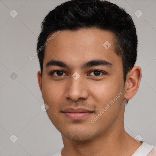 Joyful latino young-adult male with short  black hair and brown eyes