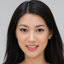 Joyful asian young-adult female with long  brown hair and brown eyes