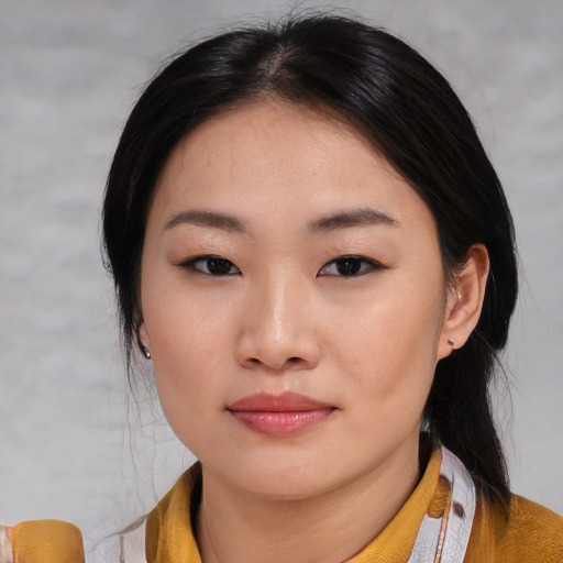 Joyful asian young-adult female with medium  black hair and brown eyes
