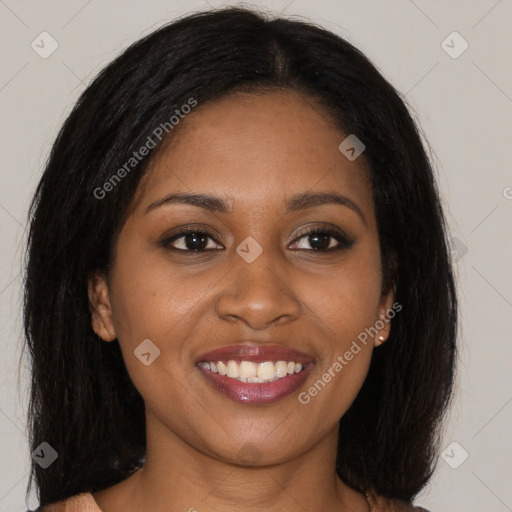 Joyful black young-adult female with long  brown hair and brown eyes