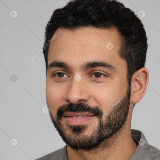 Joyful latino young-adult male with short  black hair and brown eyes