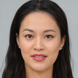 Joyful asian young-adult female with long  brown hair and brown eyes