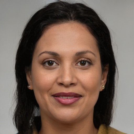 Joyful white adult female with medium  brown hair and brown eyes