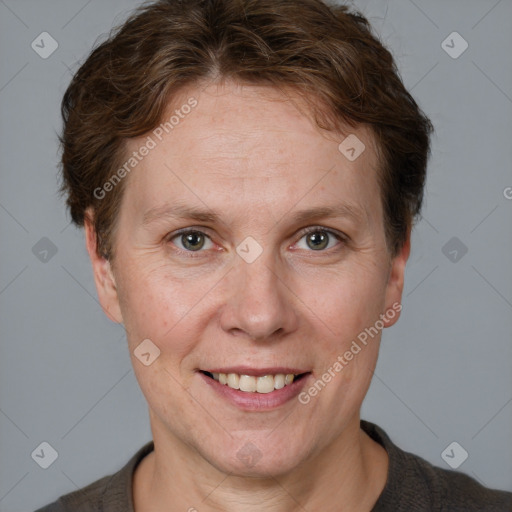 Joyful white adult female with short  brown hair and grey eyes