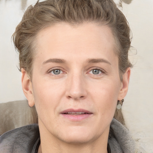 Joyful white adult female with medium  brown hair and grey eyes