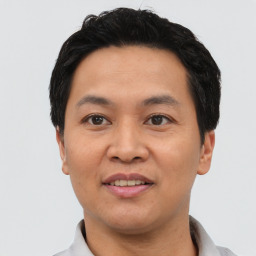 Joyful asian young-adult male with short  black hair and brown eyes