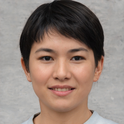 Joyful asian young-adult female with short  brown hair and brown eyes