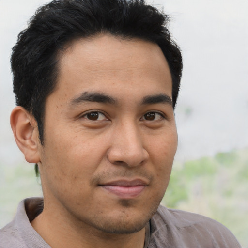 Joyful asian young-adult male with short  brown hair and brown eyes