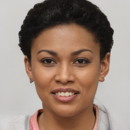 Joyful black young-adult female with short  brown hair and brown eyes