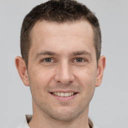 Joyful white adult male with short  brown hair and brown eyes