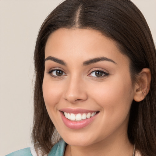 Joyful white young-adult female with long  brown hair and brown eyes