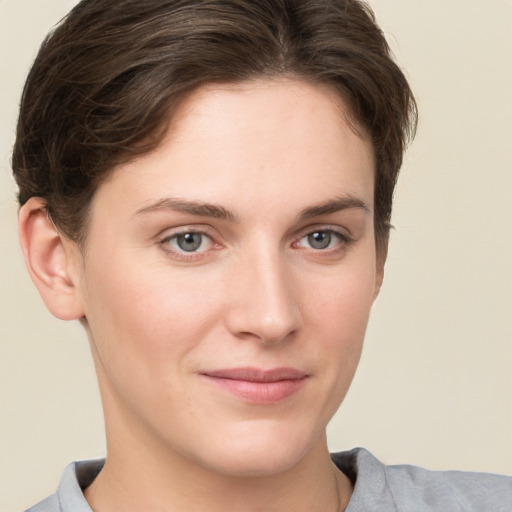 Joyful white young-adult female with short  brown hair and grey eyes