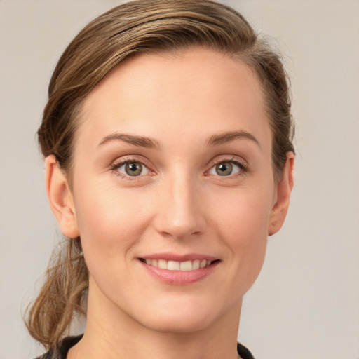 Joyful white young-adult female with short  brown hair and grey eyes