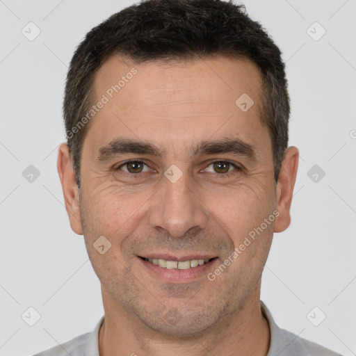 Joyful white adult male with short  brown hair and brown eyes